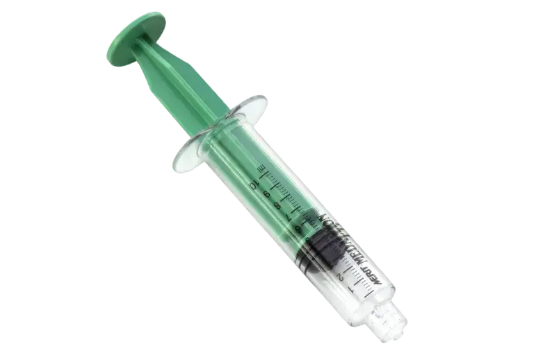 A syringe with a green tip positioned on a black background, highlighting its design and color contrast.
